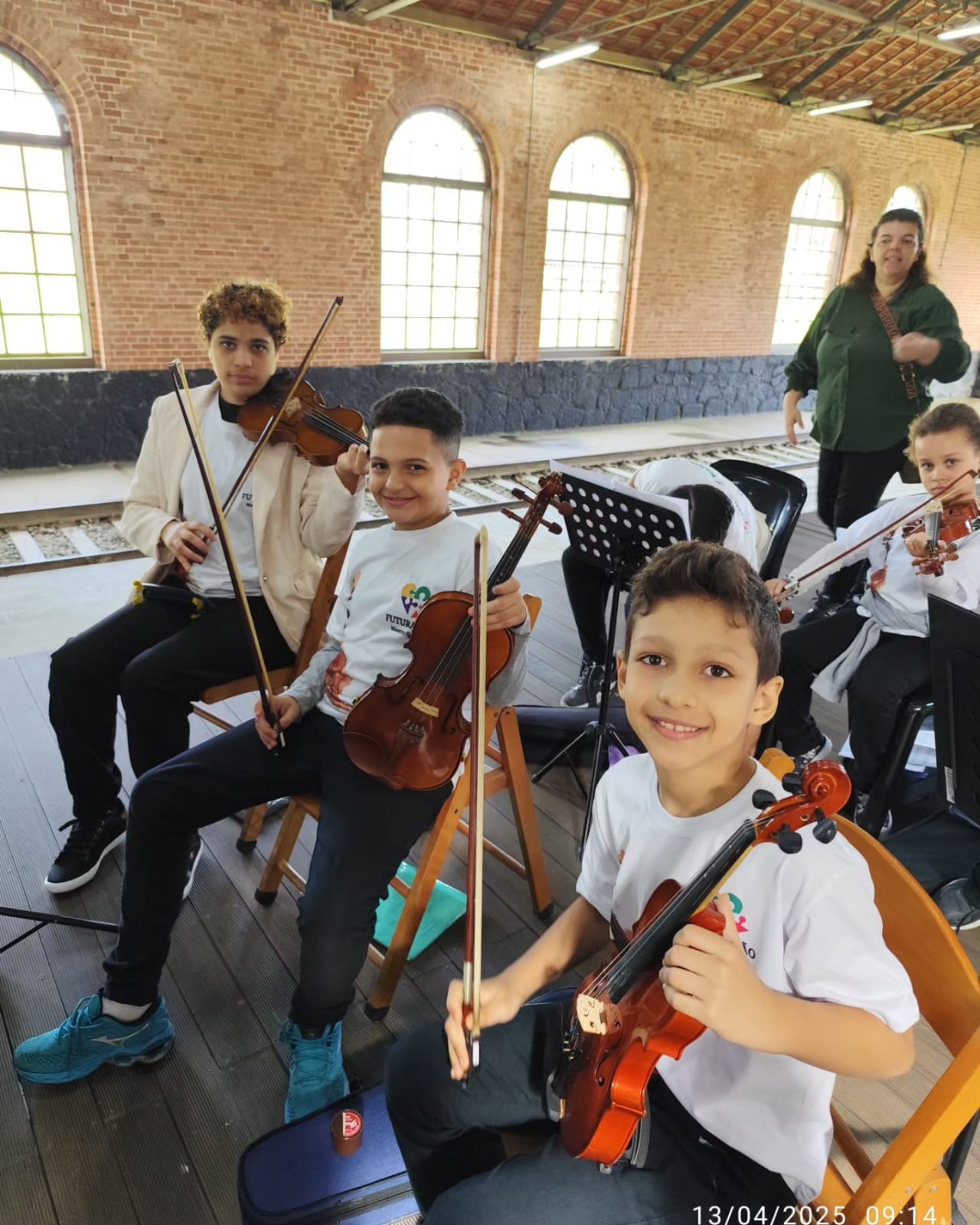 Crianças tocando violino em ensaio
